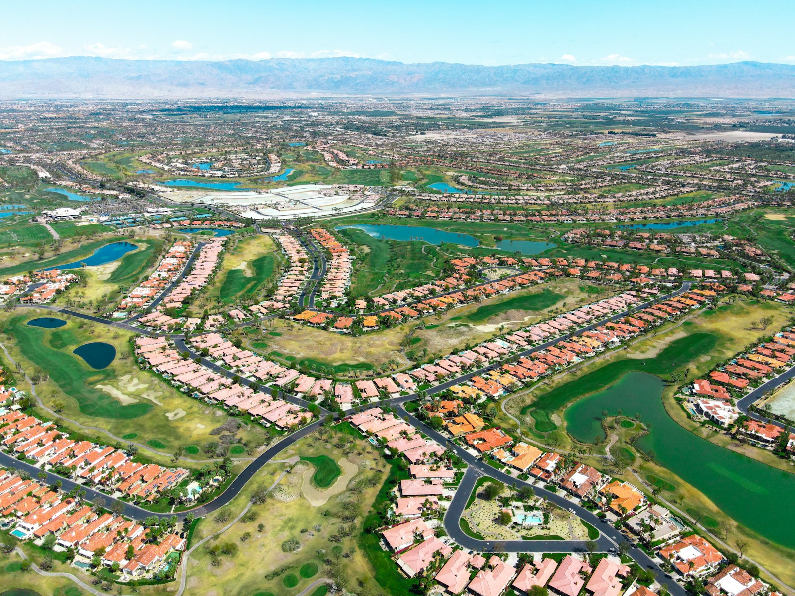 Aerial view of a sprawling suburban neighborhood with golf courses.